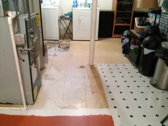 Unfinished basement with two layers of vinyl flooring