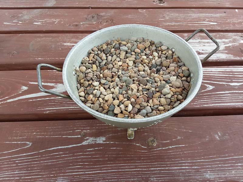 Drying pea gravel in a colander | Potting faux succulents with gravel glue | stowandtellu.com