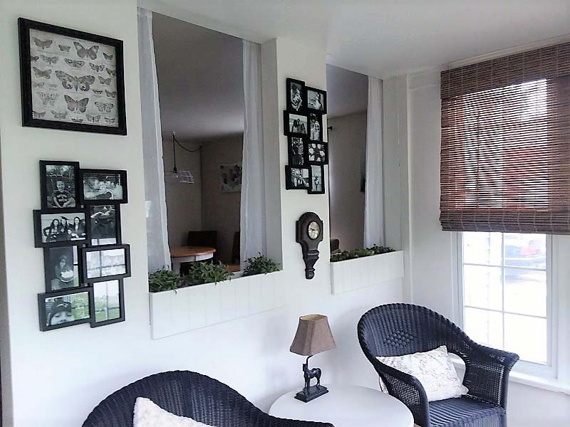 Gallery Wall in Small Sun Porch Sitting Area Makeover