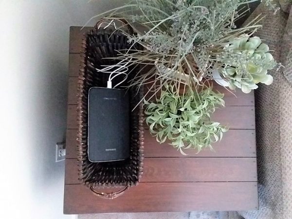 Tablet charging in basket on table top