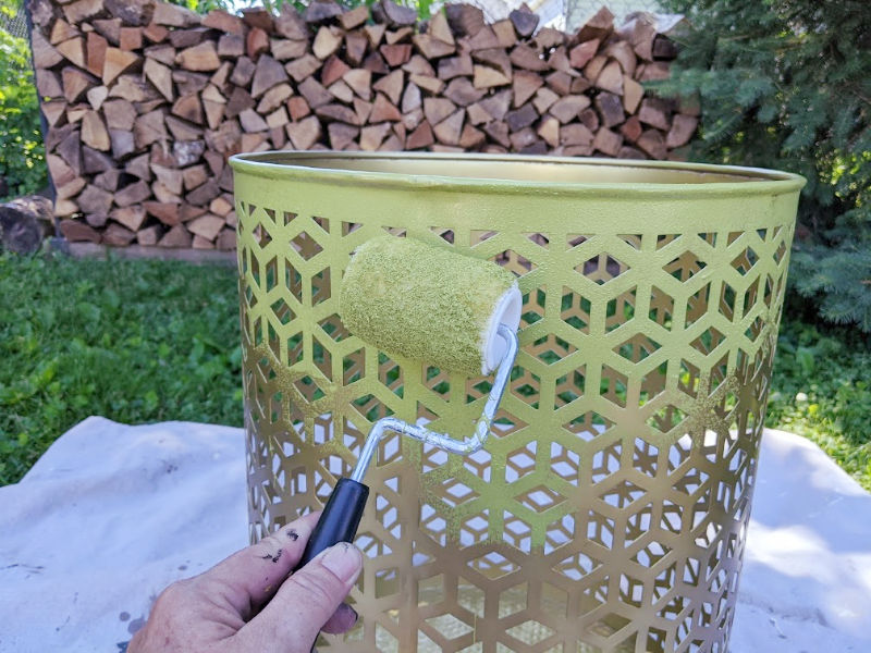 Painting outdoor metal table with a paint roller