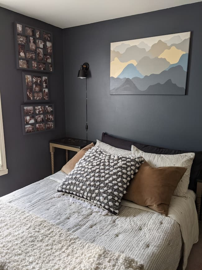 dark blue bedroom with gray bedding